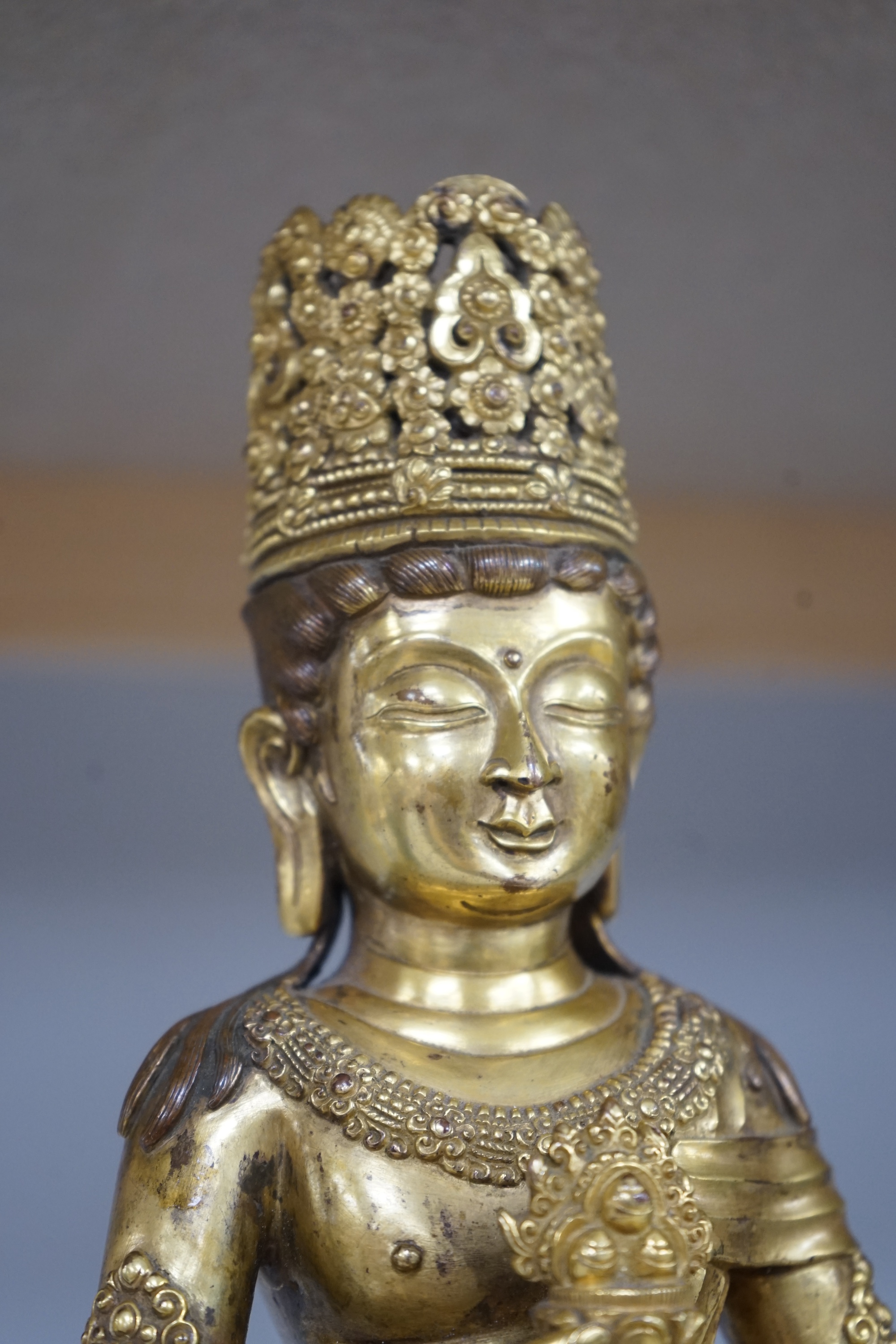 Tibetan School, 20th century gilt bronze figure of a seated deity, 31cm high. Condition - good